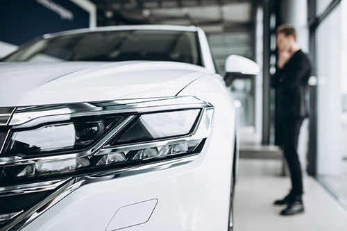 Man looking at a car and thinking of a purchase indoor Car Storage